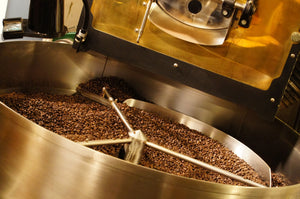 Close-up of dark roasted coffee beans cooling after roasting at San Francisco Coffee Roasting Company in Atlanta.